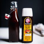 Bottle of homemade tonkatsu sauce next to bottle of bull dog sauce.
