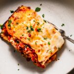 Piece of lasagna in serving dish.