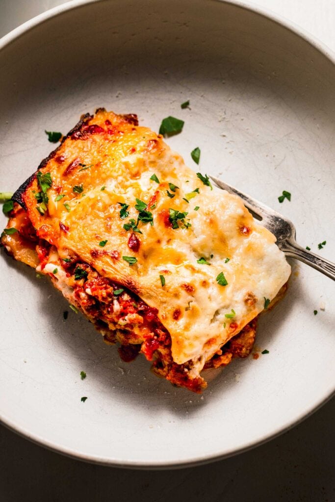 Piece of lasagna in serving dish.