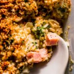 Spoon taking scoop out of leftover ham casserole.