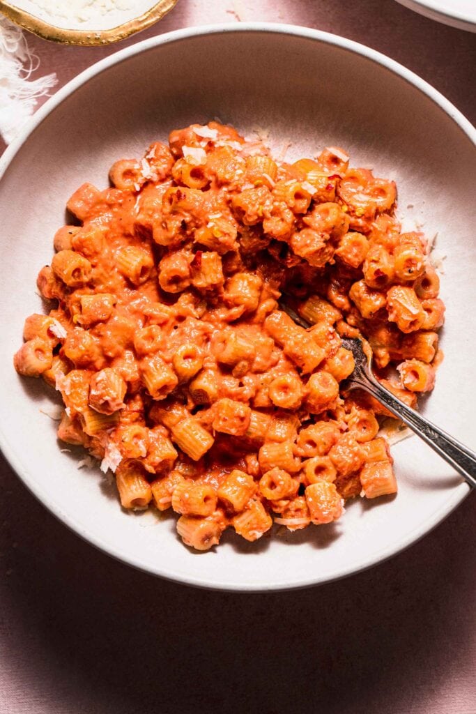 Overhead close up of bowl of pink sauce pasta. 