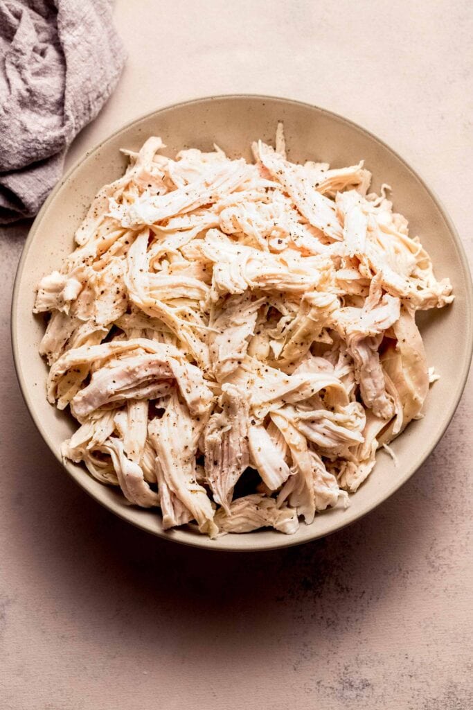 Bowl of shredded chicken cooked sous vide. 