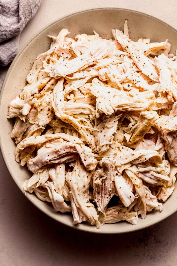 Overhead close up of bowl of sous vide shredded chicken. 