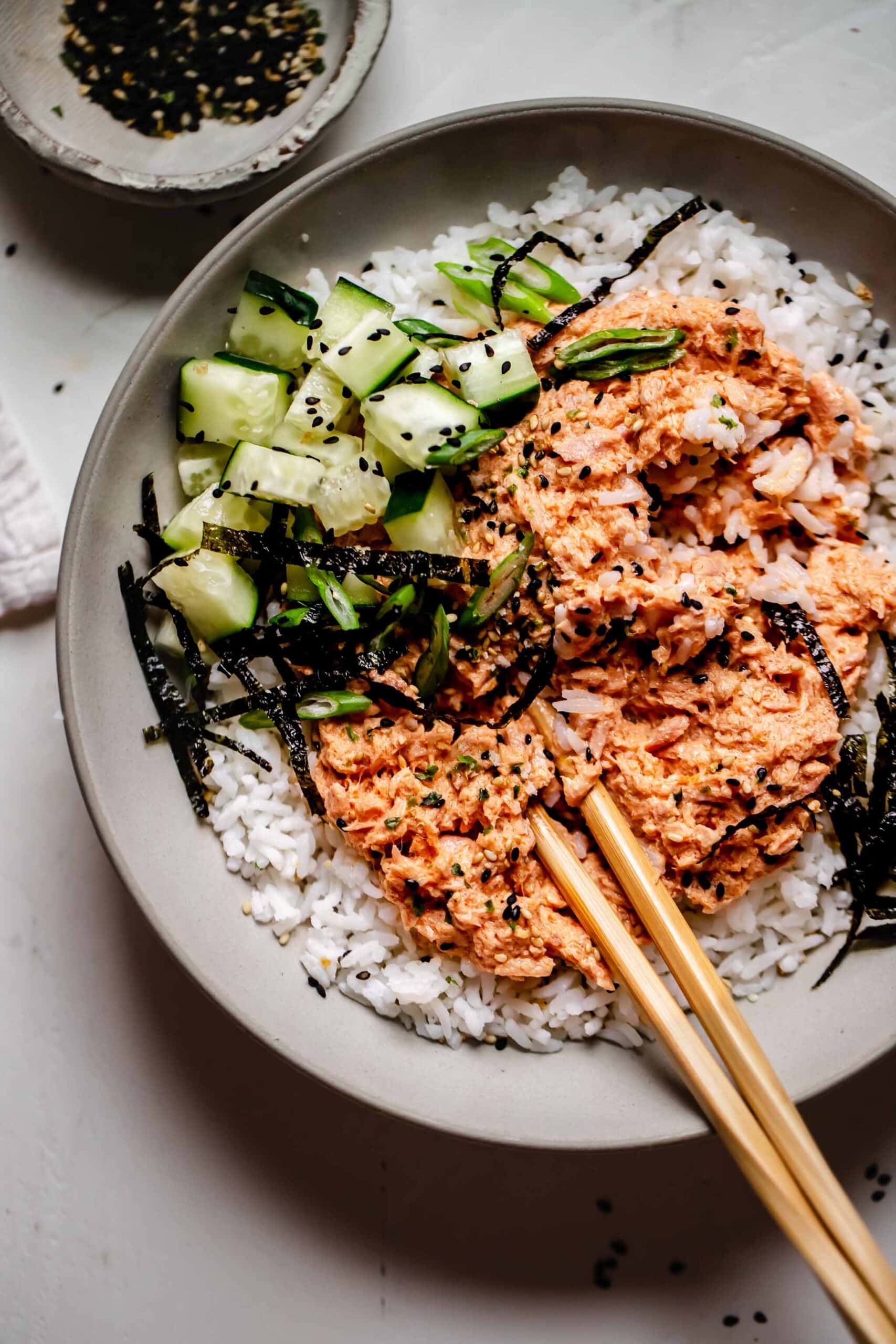Overhead shot of bowl of tuna rice with chopsticks.