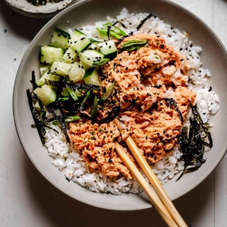 Overhead shot of bowl of tuna rice with chopsticks.