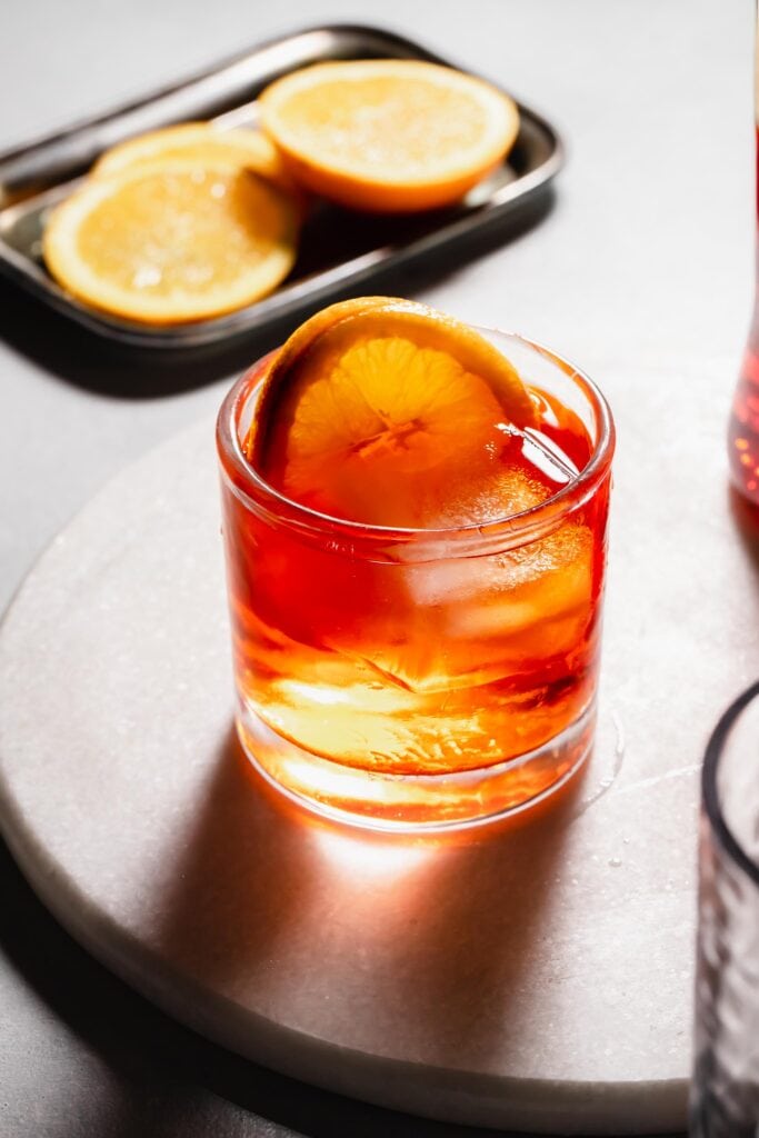 Aperol negroni in glass with orange slices. 