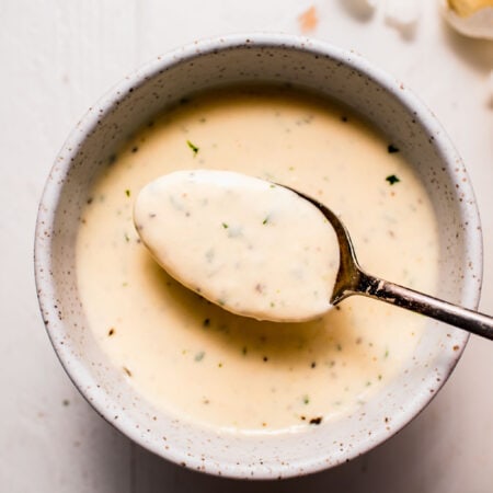 Spoonful of creamy garlic sauce.