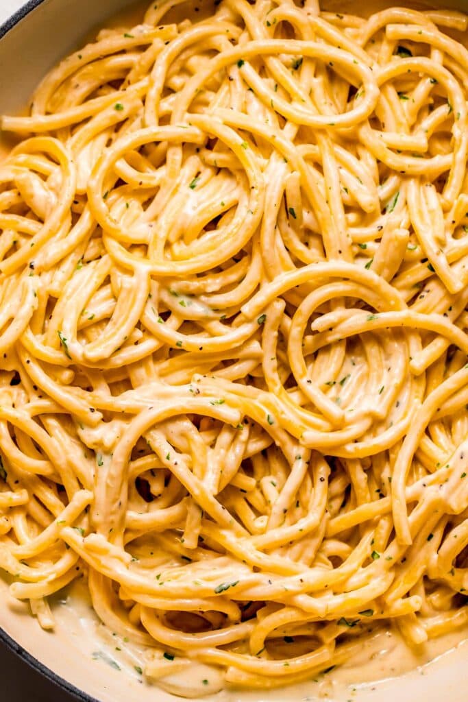 Close up of garlic sauce tossed with pasta. 