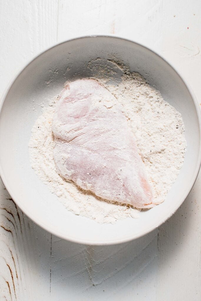 Chicken breast coated in flour. 