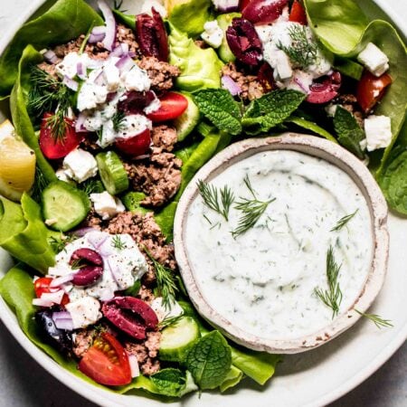 Lamb lettuce cups arranged on platter.