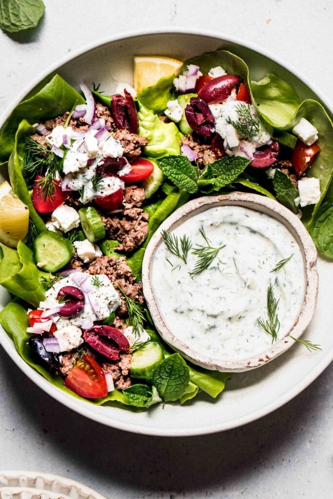 Lamb lettuce cups arranged on platter.