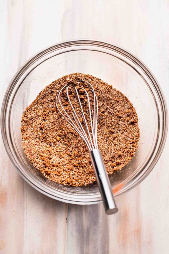 Prepared Salmon dry rub in bowl with whisk.