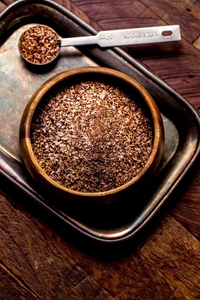 Bowl of dry rub on wooden counter. 