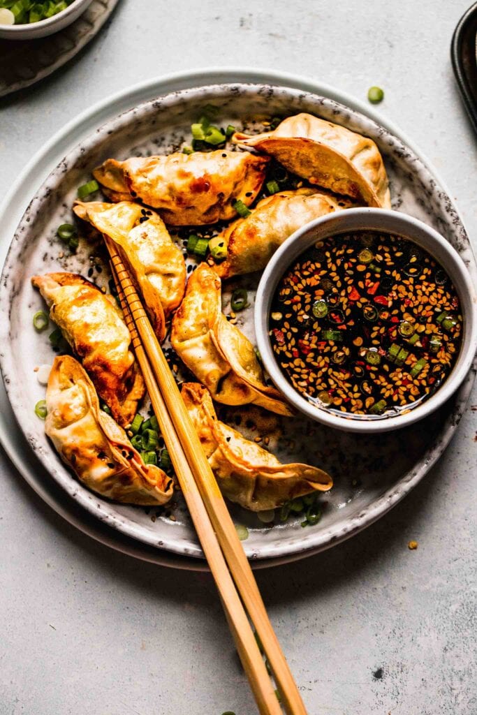 Potstickers and sauce on plate. 