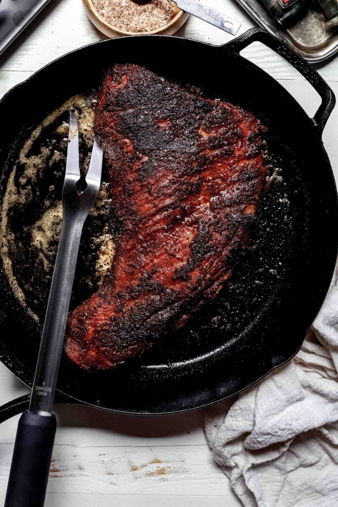 Tri tip being seared in skillet.