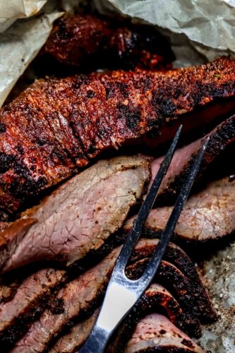 Traeger smoked tri tip sliced on serving tray.