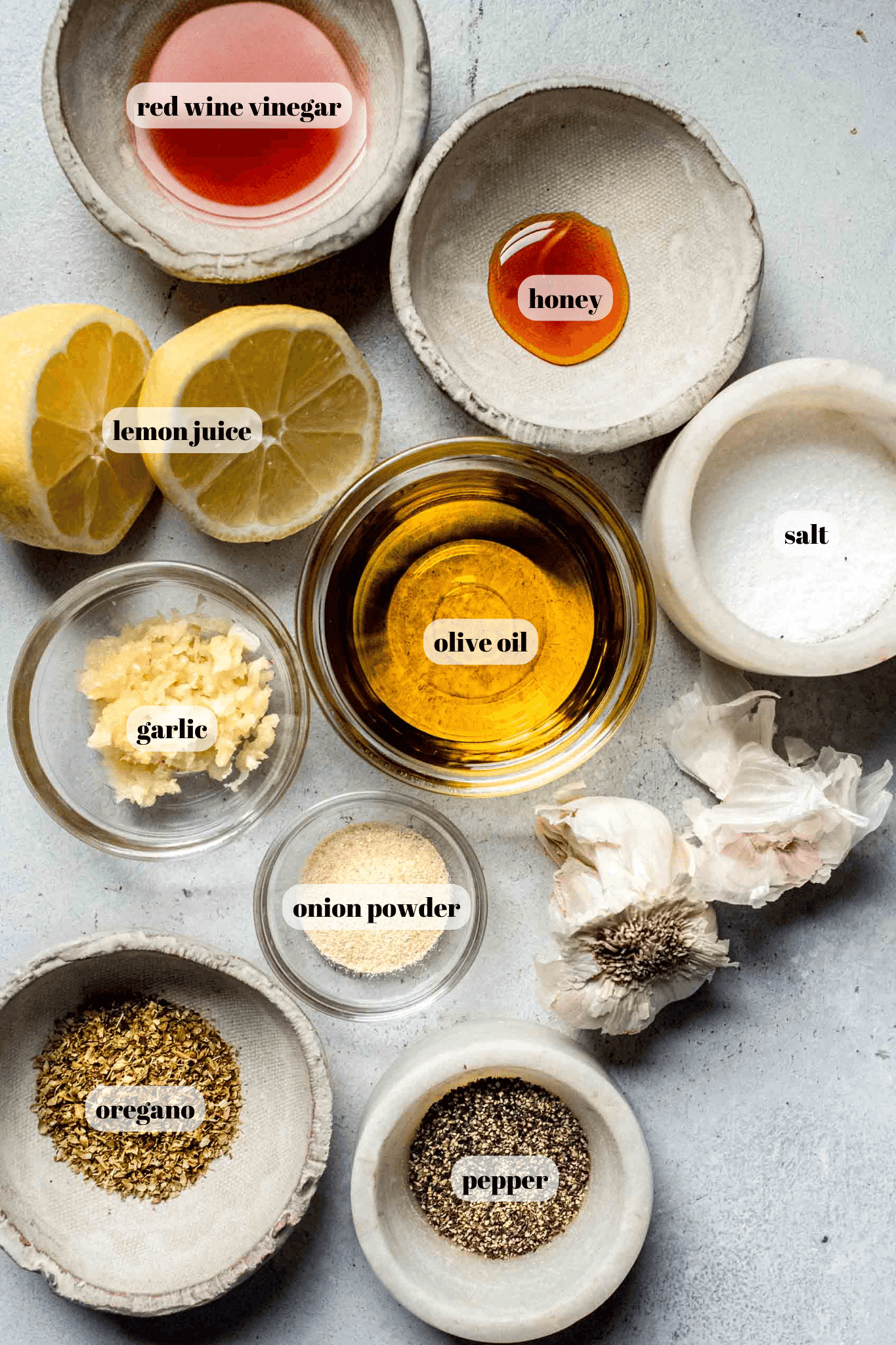 Ingredients for greek chicken labeled on counter. 