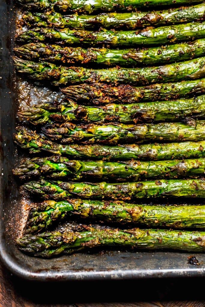 Close up of charred asparagus on tray. 