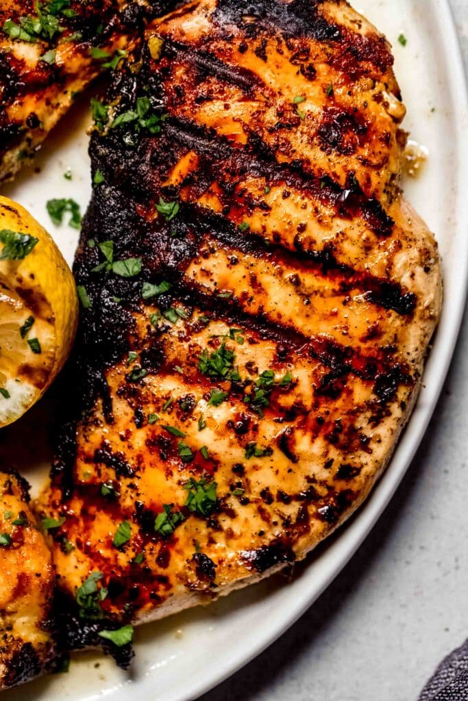 Close up of chicken breast with grill marks.