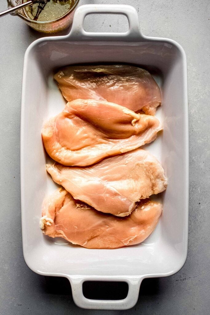 Chicken breasts in baking dish.