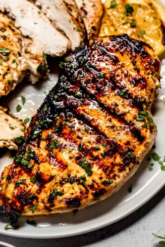Close up of chicken breast with grill marks.