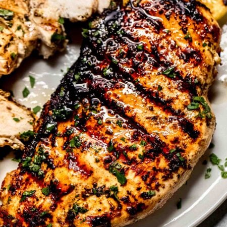 Close up of chicken breast with grill marks.