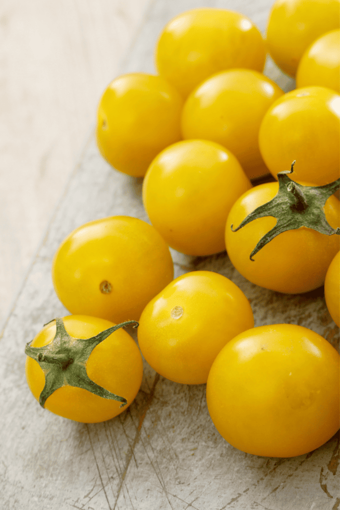 Yellow tomatoes on counter. 