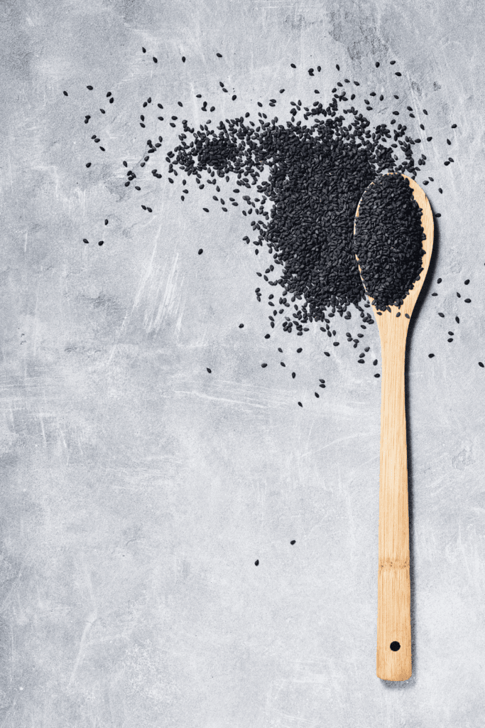 Black sesame seeds on spoon.