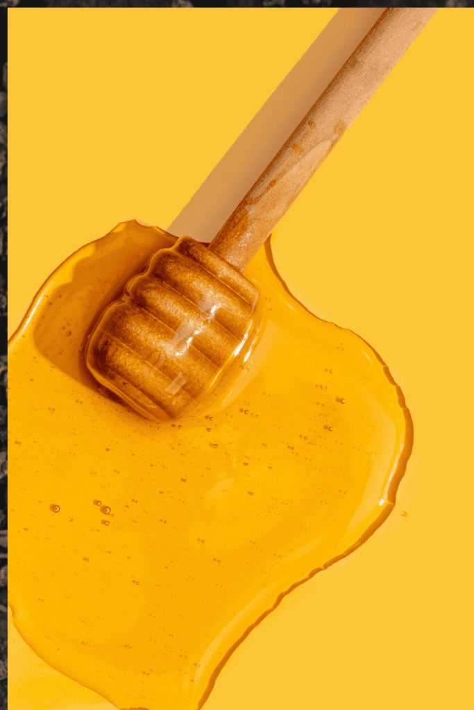Honey wand on yellow background. 
