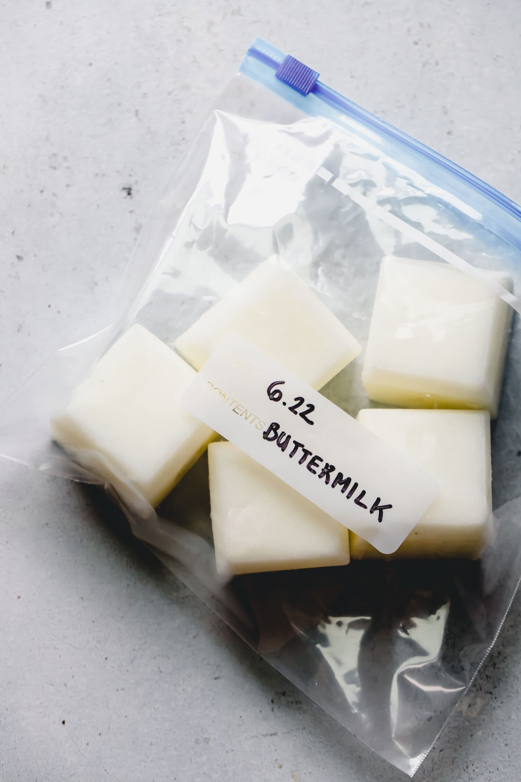 Frozen buttermilk cubes in labeled ziploc bag.