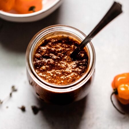 Jar of jerk sauce with spoon.
