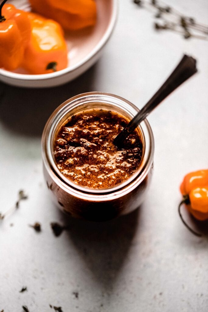 Jar of jerk sauce with spoon.