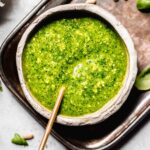 Overhead close up of bowl of pesto genovese with spoon.