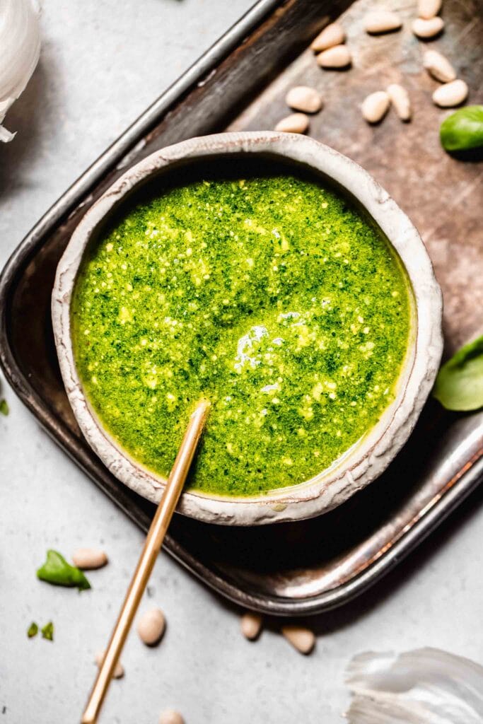 Overhead close up of bowl of pesto genovese with spoon.