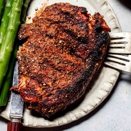 Steak on plate with asparagus spears.