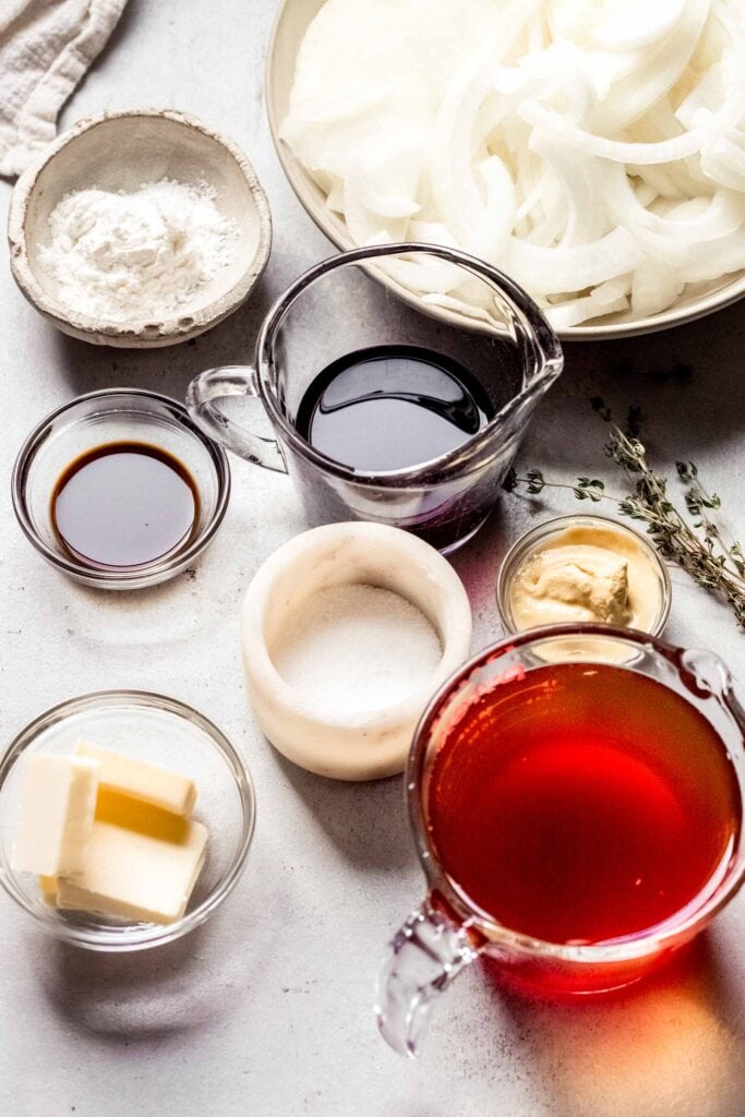 Ingredients for onion red wine gravy on counter. 
