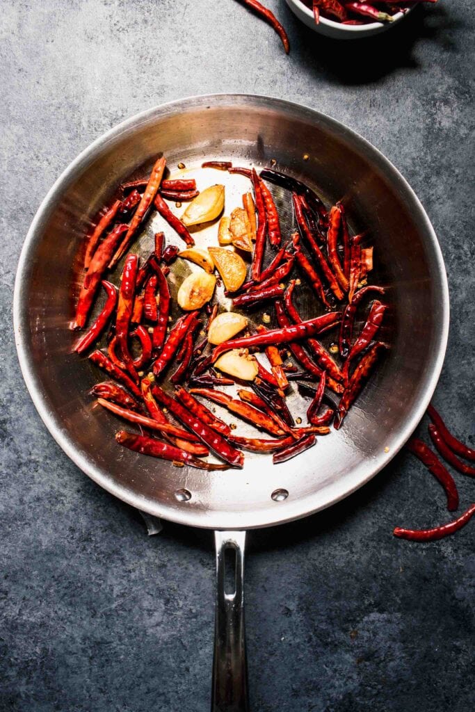 Toasted peppers and garlic in skillet.