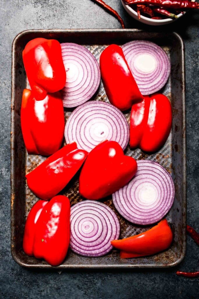 Pepper and onion slices on sheet pan. 