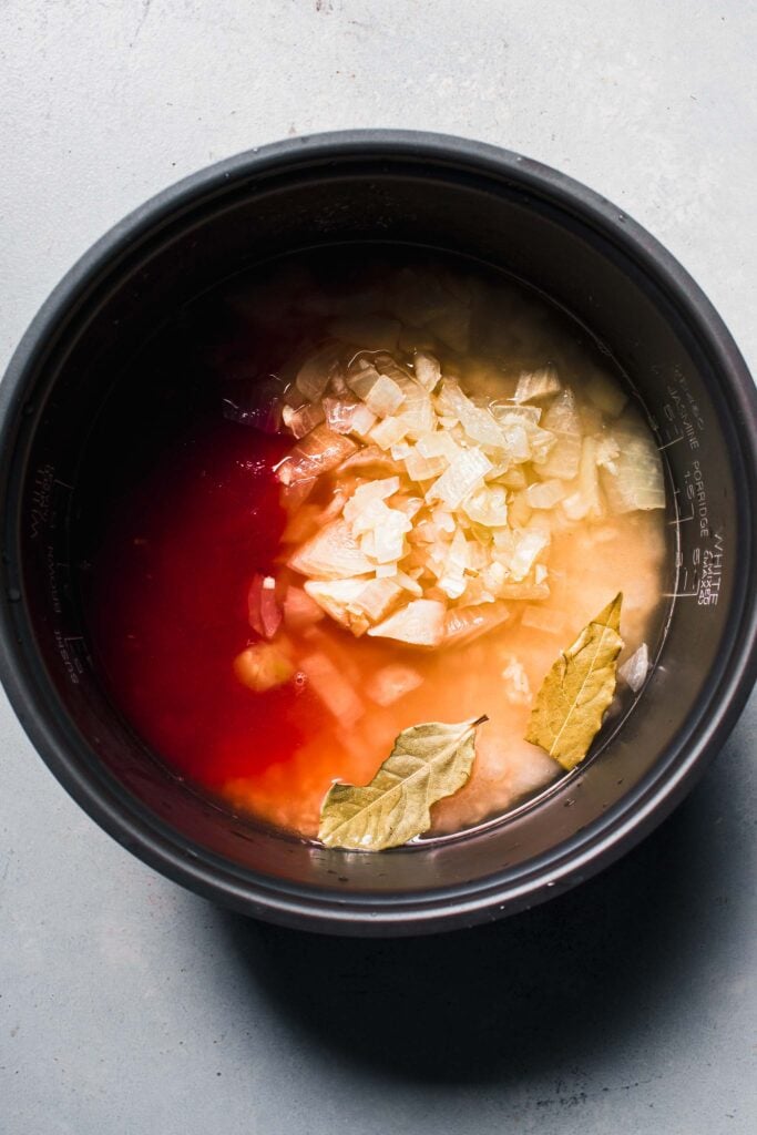 Ingredients for mexican rice in rice cooker.