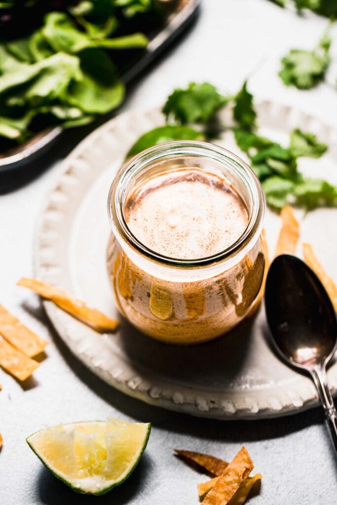 Jar of southwest salad dressing with spoon. 