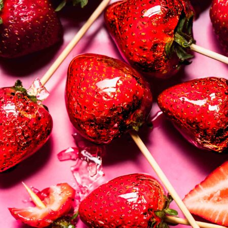 Tanghulu strawberries on pink plate.