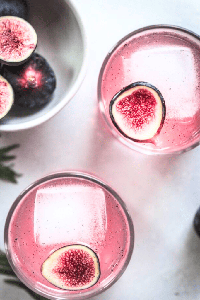 Overhead shot of two fig cocktails in glasses. 