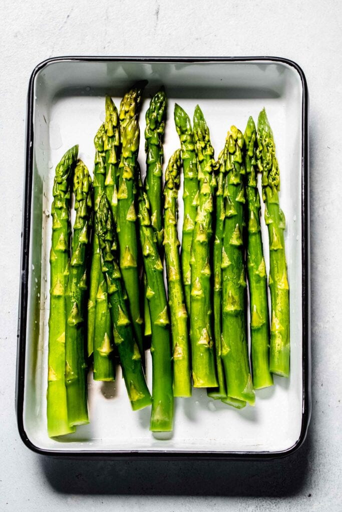 Blanched asparagus on tray.