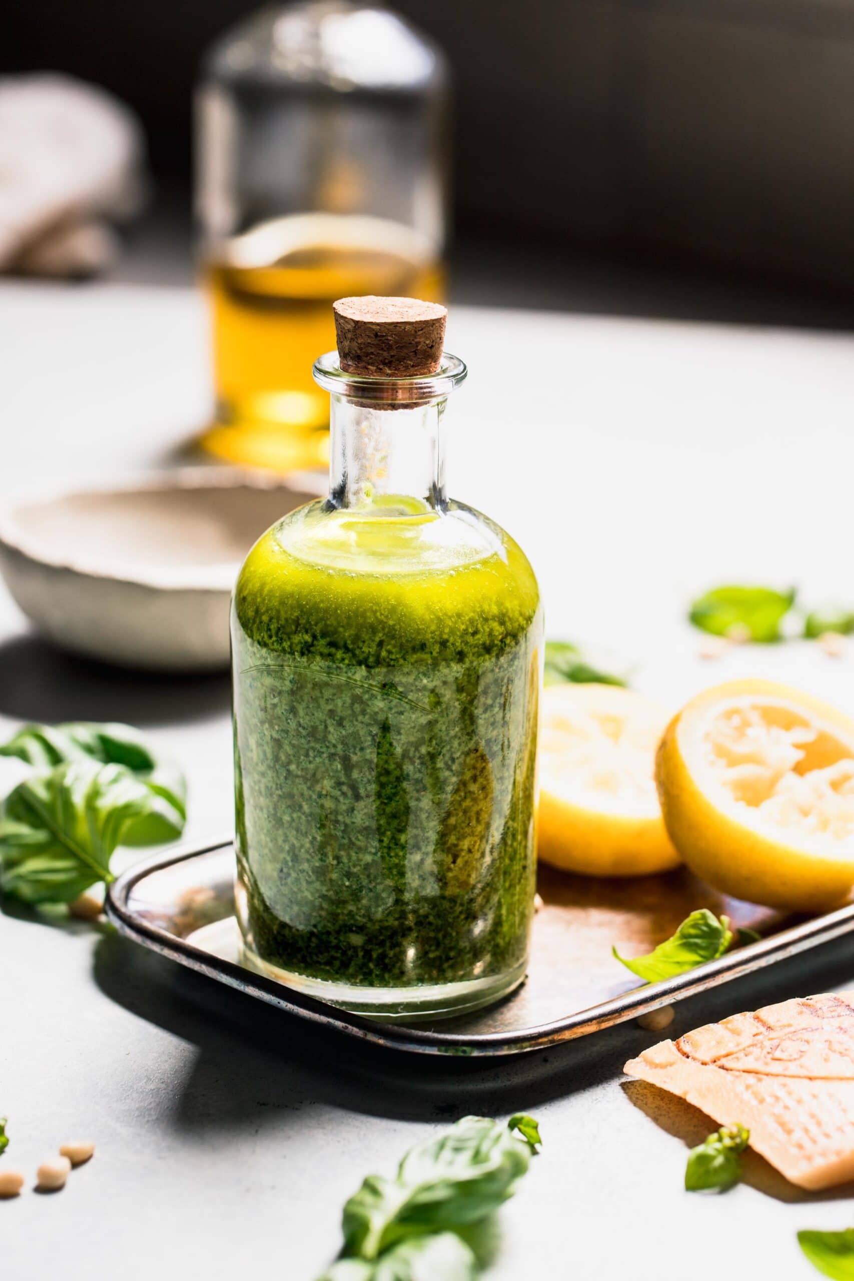 Pesto salad dressing in small bottle.