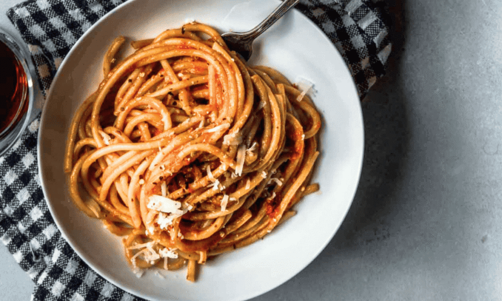 Roasted Tomato Pasta Sauce in bowl tossed with bucatini.