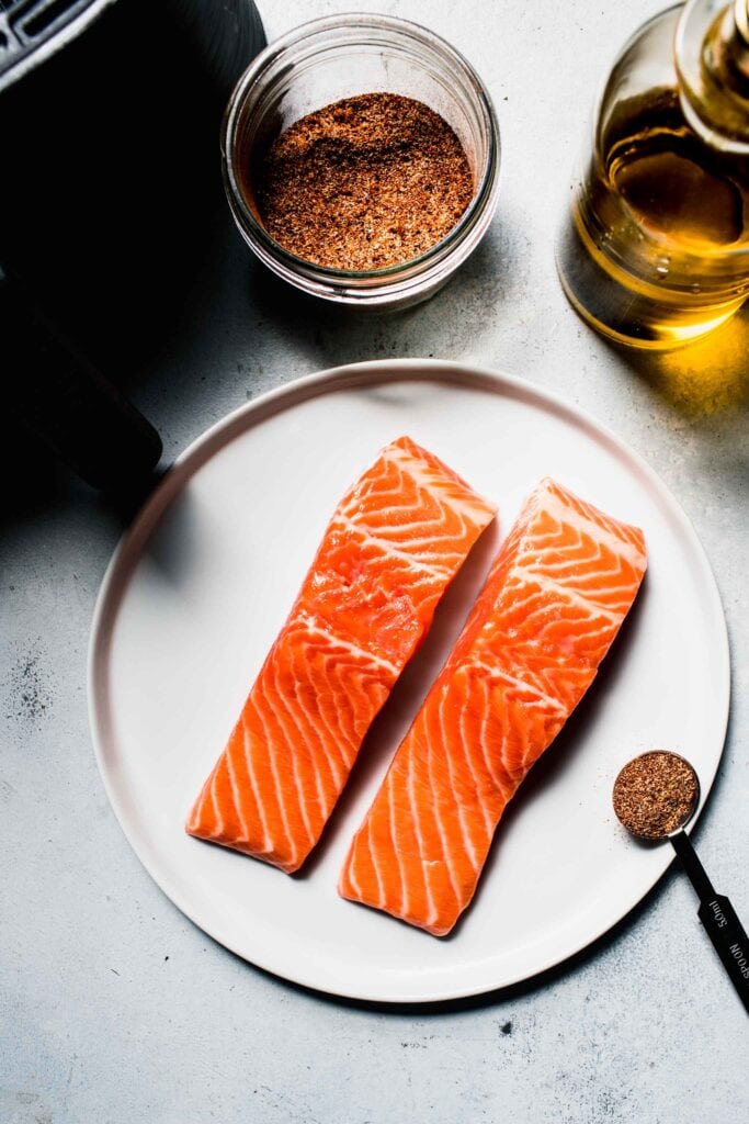 Raw salmon filets on plate. 