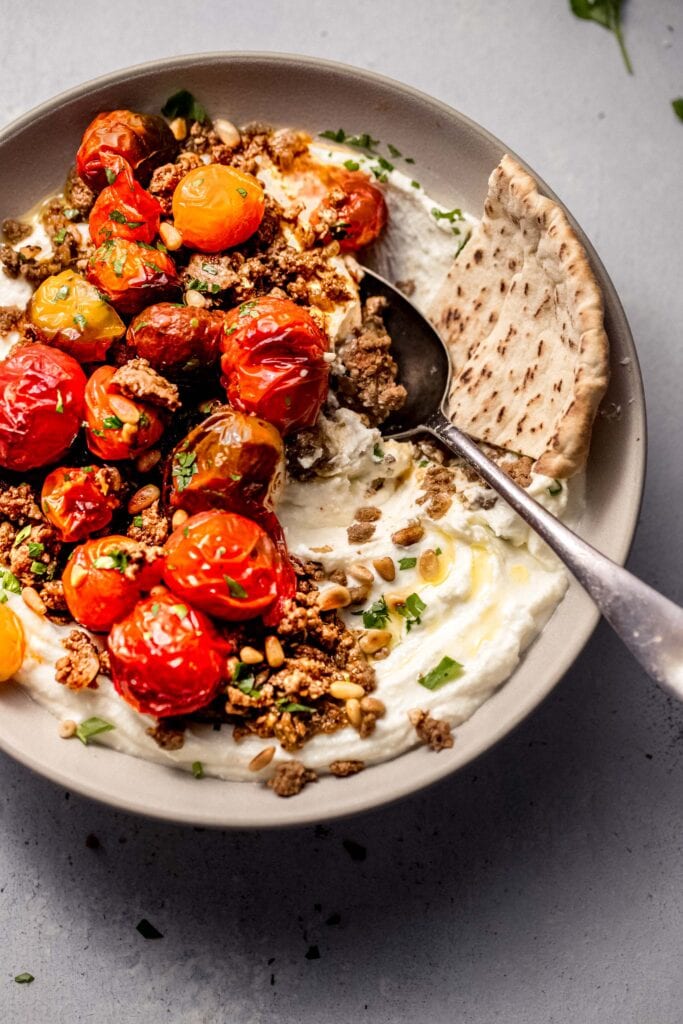 Spoon dipped into whipped feta dip.