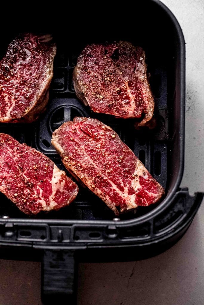 Raw filets in air fryer basket. 