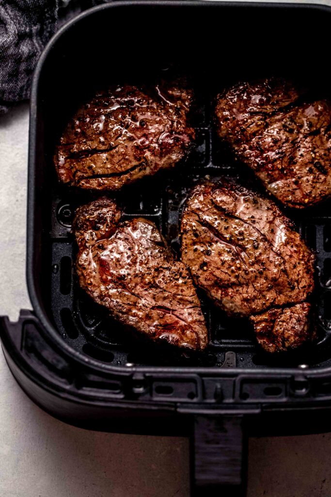 Cooked filets in air fryer basket. 