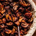 Crispy air fryer mushrooms in bowl with spoon.